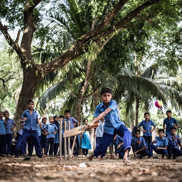 Rakib Hosain Sabbir, 9, a star cricketer at his primary school in Bangladesh, receives tutoring after school