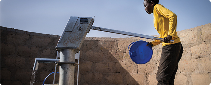 A child using a water pump