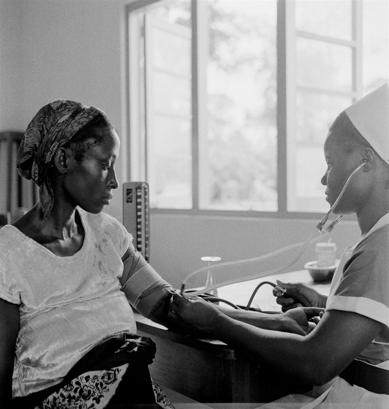 Nurse-Midwife Emilia Akogveram (right), checks a pregnant woman's blood pressure at a UNICEF-assisted clinic.