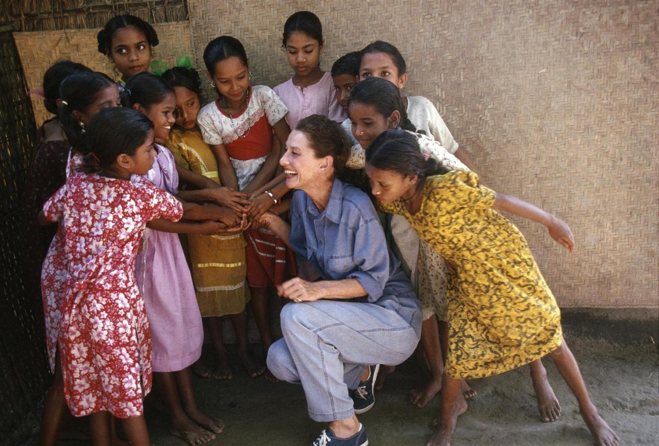 UNICEF Goodwill Ambassador Audrey Hepburn laughs with girls.