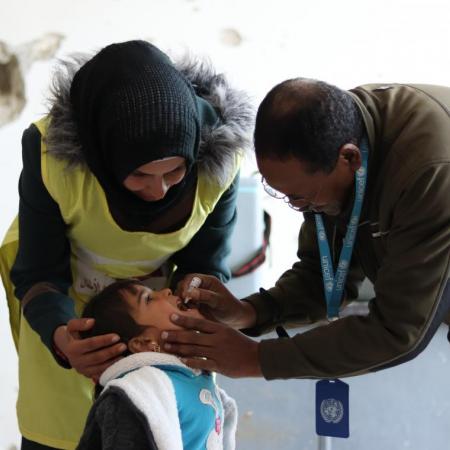 A child receives an oral vaccination.