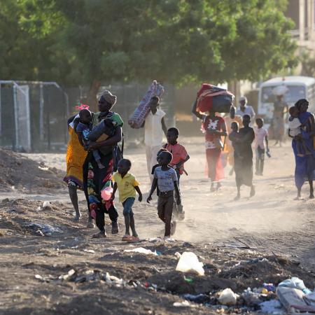 On 19 April 2023, people flee their neighbourhoods amid fighting between the army and paramilitaries in Khartoum, Sudan.