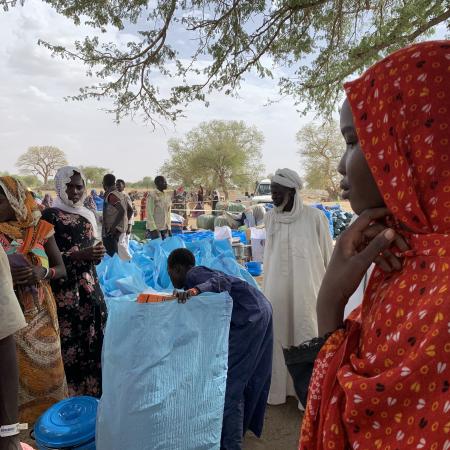 On 30 April 2023, 16-year-old Ikhram, right, waits in line to collect non-food items distributed by UNICEF and its partners in Kounfroun, Chad.