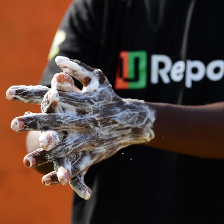 A U-Reporter demonstrates proper handwashing techniques in Cote D'Ivoire.
