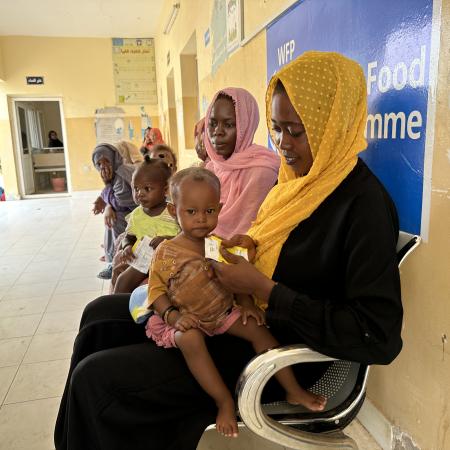 On 13 September 2023, mothers feed their children with ready-to-use therapeutic food (RUTF) at the Ahmed Gasim Health Centre in Port Sudan.