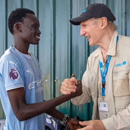 UNICEF Goodwill Ambassador Liam Neeson meets 20-year-old Alan at the Gredo Youth Centre in Juba, South Sudan.
