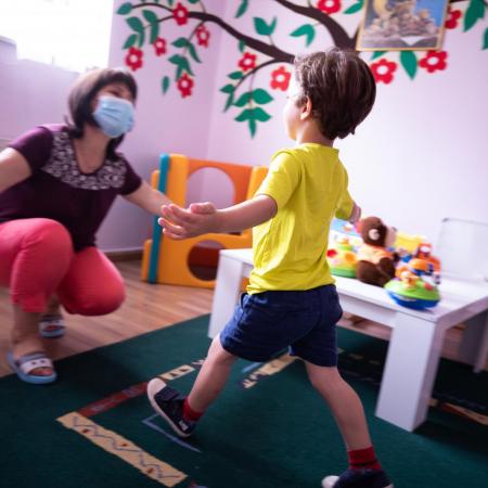 Childcare worker and child at a centre in Albania.