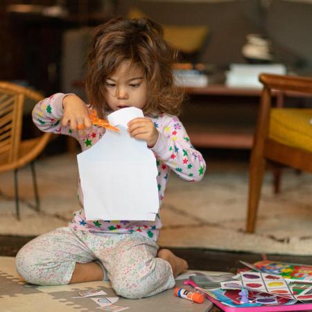 A little girl does crafts at home during COVID-19 lockdowns.