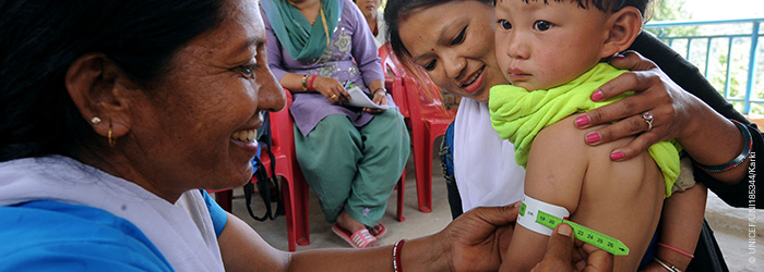 Child measured for malnutrition