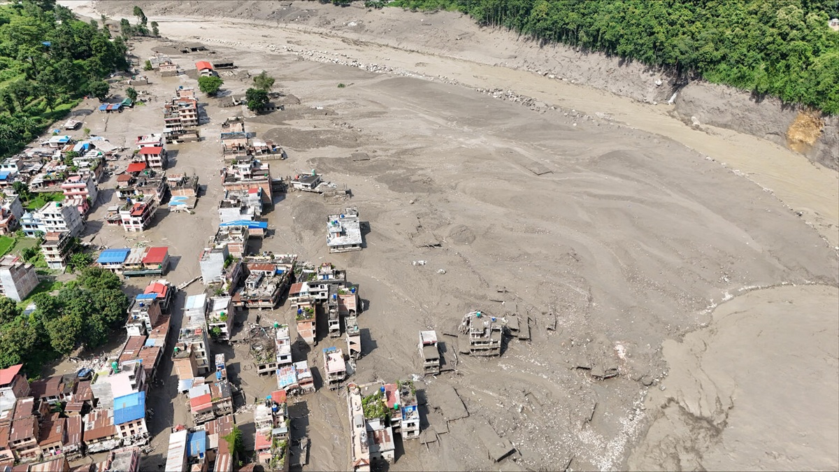 A settlement covered in mud caused by flash flooding. 