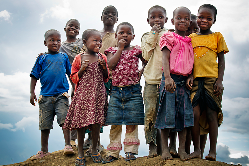 A group of children standing on a hilltop