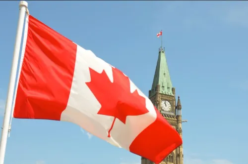 A Canadian flag flies in front of Parliament in Ottawa, Ontario, Canada.