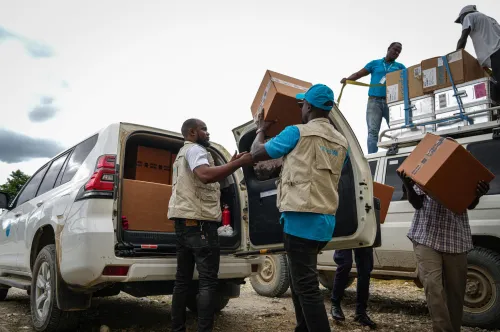 UNICEF staff loads boxes of medical kits to a UNICEF vehicle in Haiti.