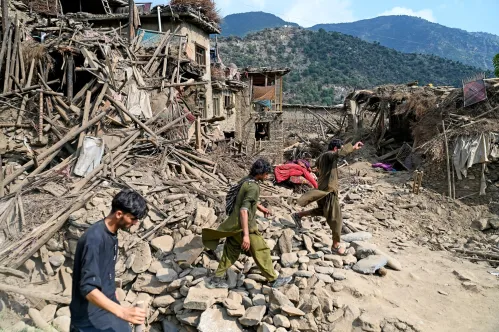 People navigate through rubble and collapsed homes after a devastating earthquake in Afghanistan.