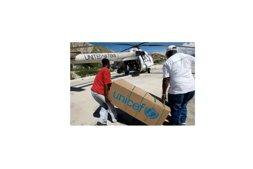 UNICEF Volunteers carry box of emergency medical supplies to treat Cholera outbreak in the port city of Gonaïves in Haiti.