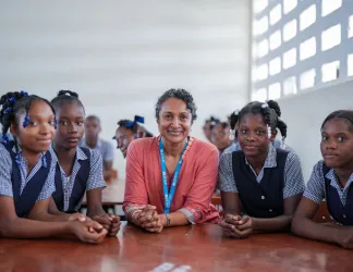 Teacher sitting with group of children