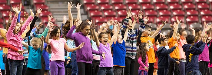 children cheering in stadium