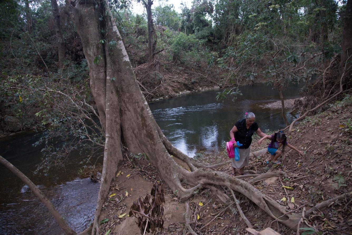 Allizon loves to play at a nearby river with her great-grandmother.