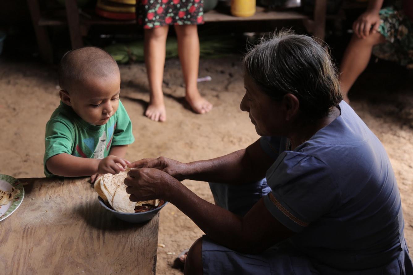 Abner helps his grandmother make tortillas at home.
