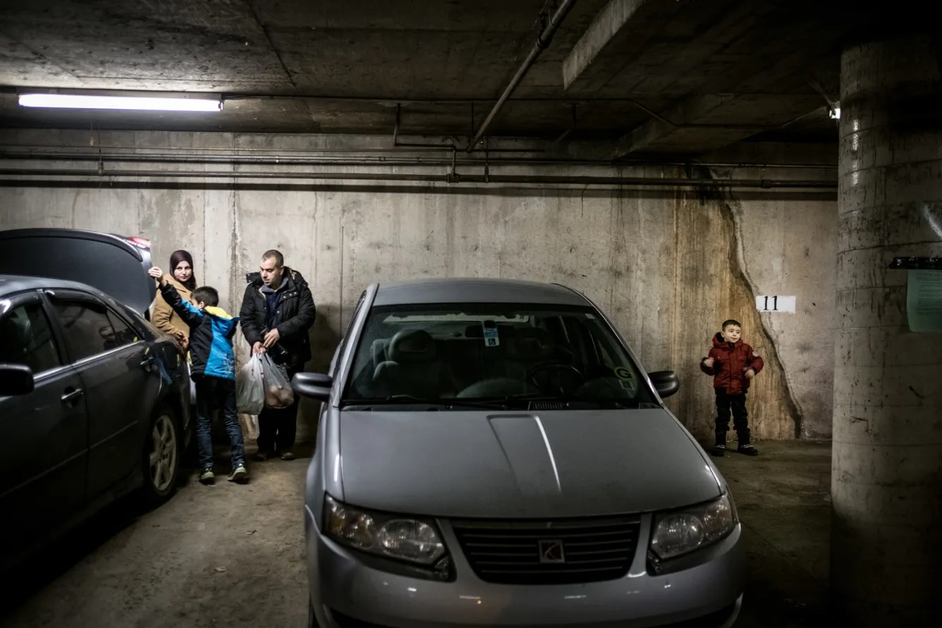 Back from shopping, the couple and their children unload their car.