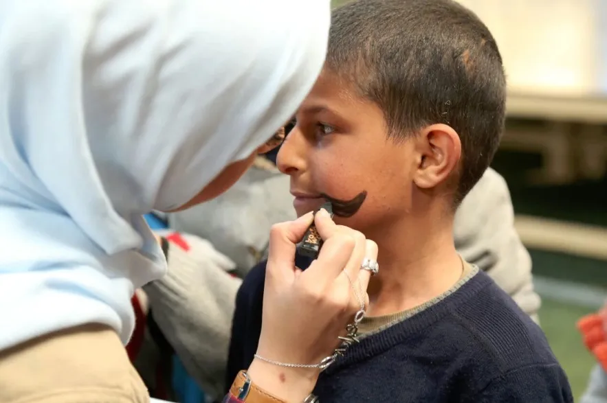 A child gets his face painted