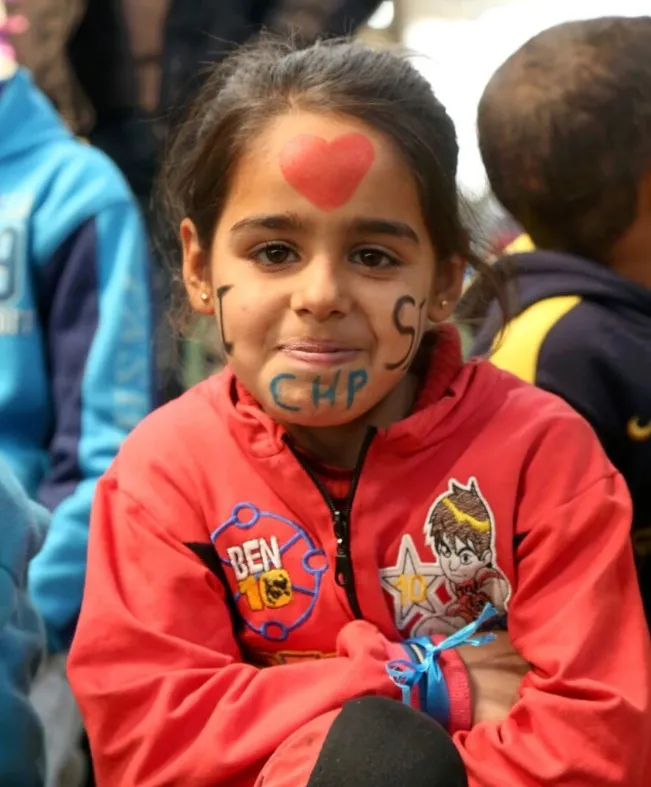 A child has her face painted