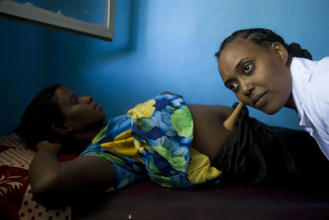 Health worker examining a pregnant woman