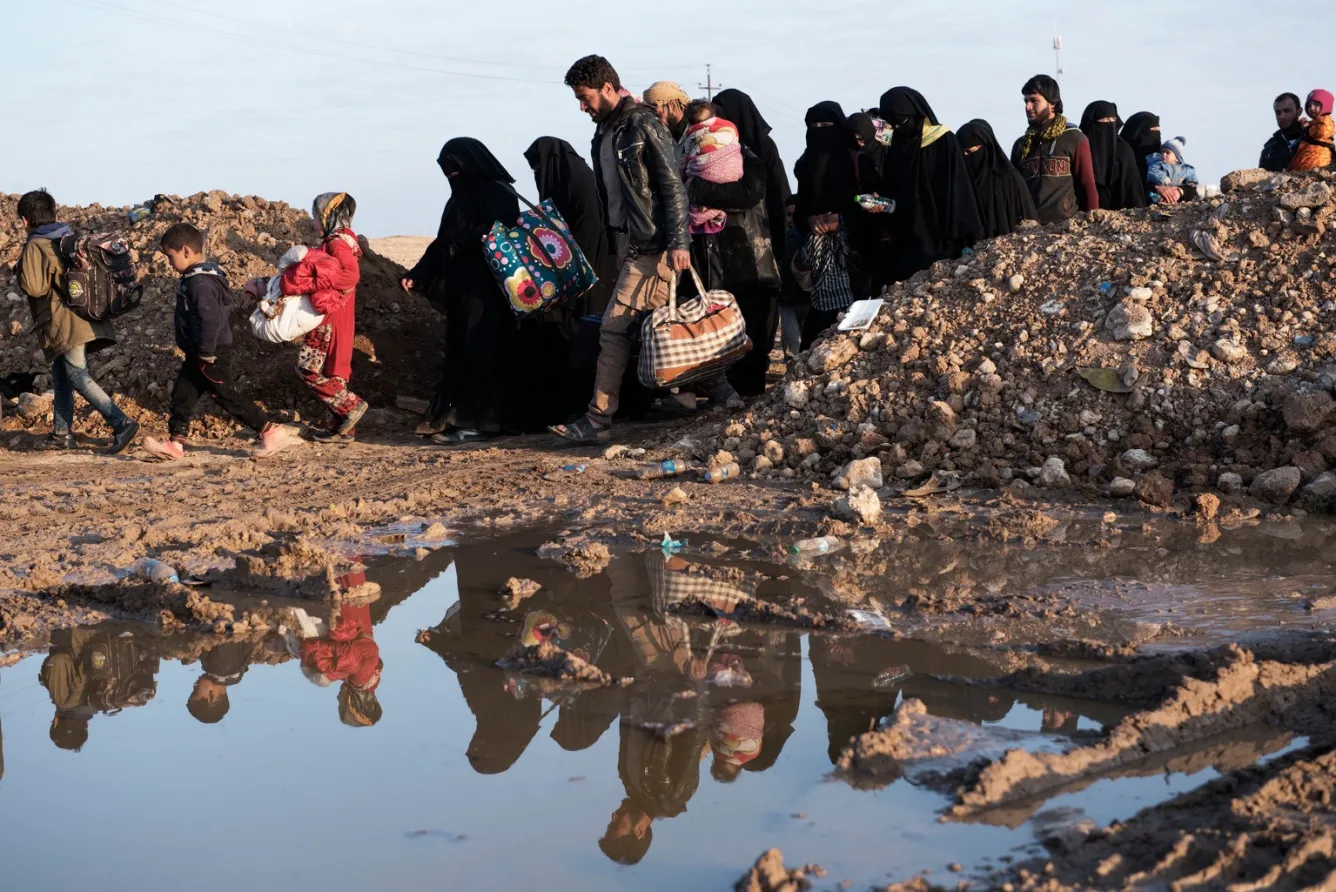 A crowd of children and adults in Iraq