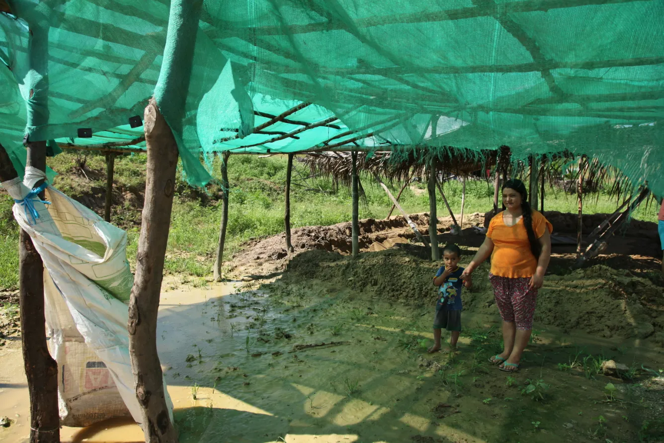 a boy stands with his mother in a flooded school