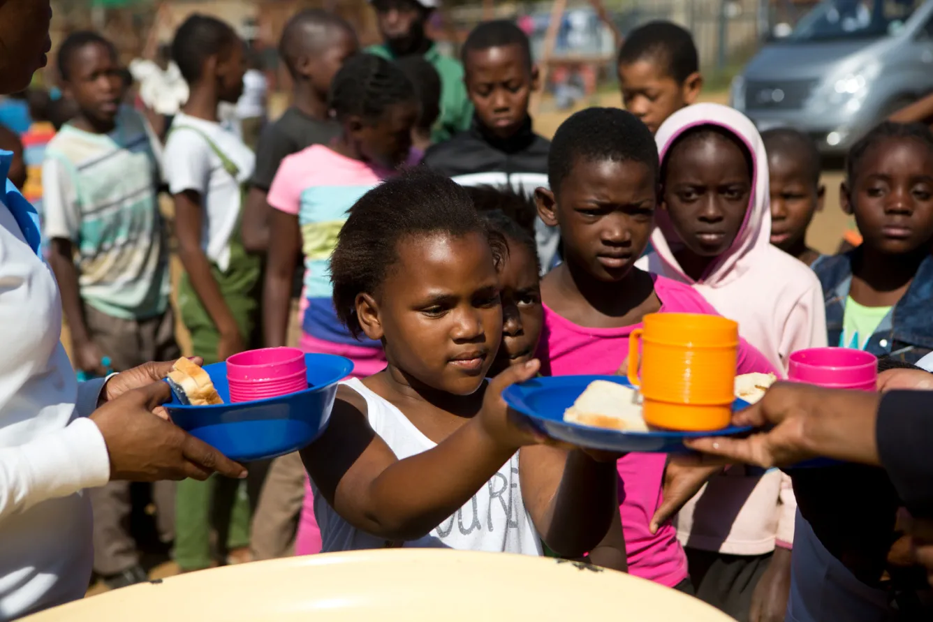 a girl accepts food at school.
