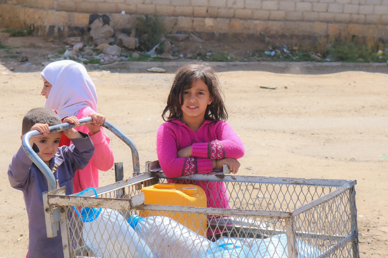 Children bring their jerrycans to fill with drinking water.