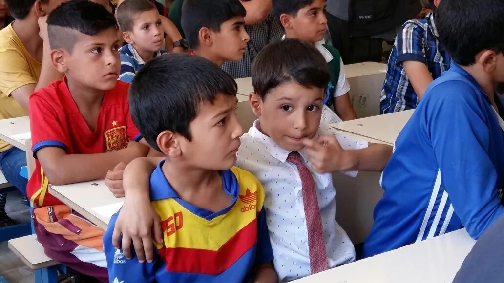 a boy comforts his friend in class