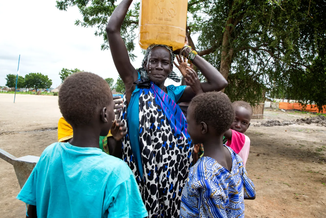 people fetch water from a well