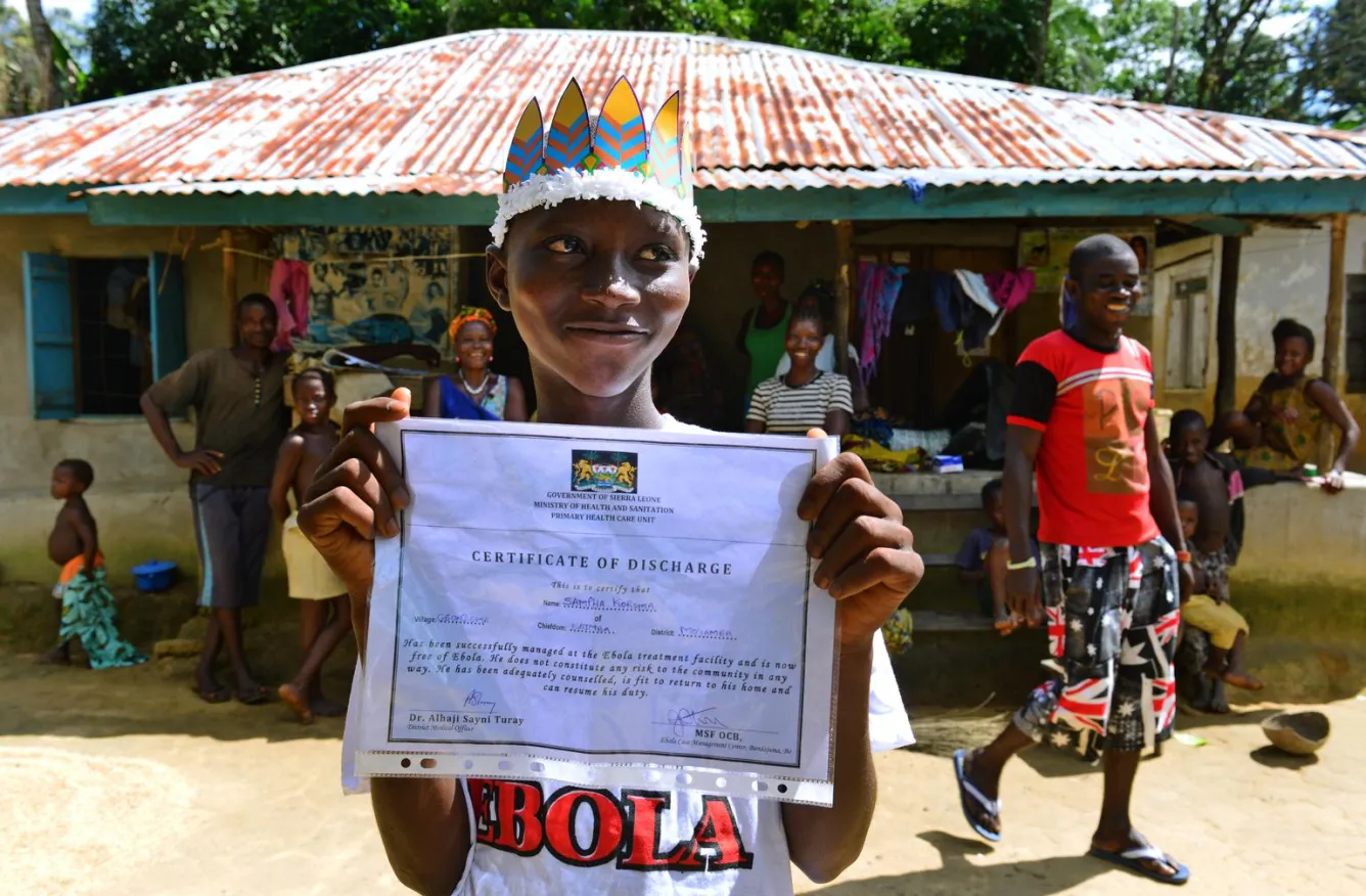 Sanfa Koroma holds his Ebola survivor certificate