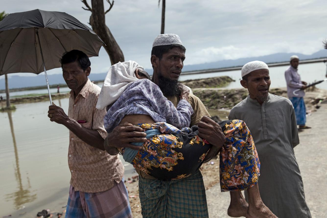 a man carries his mother to safety