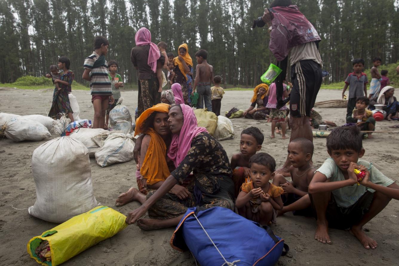 a family rests after traveling by boat to Bangladesh