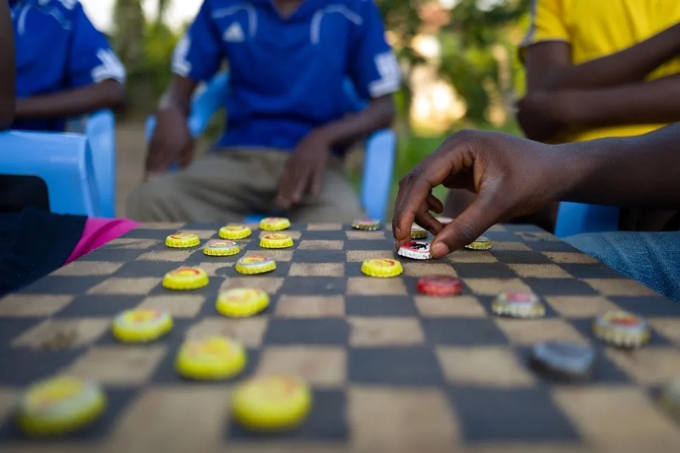 children play a game of checkers
