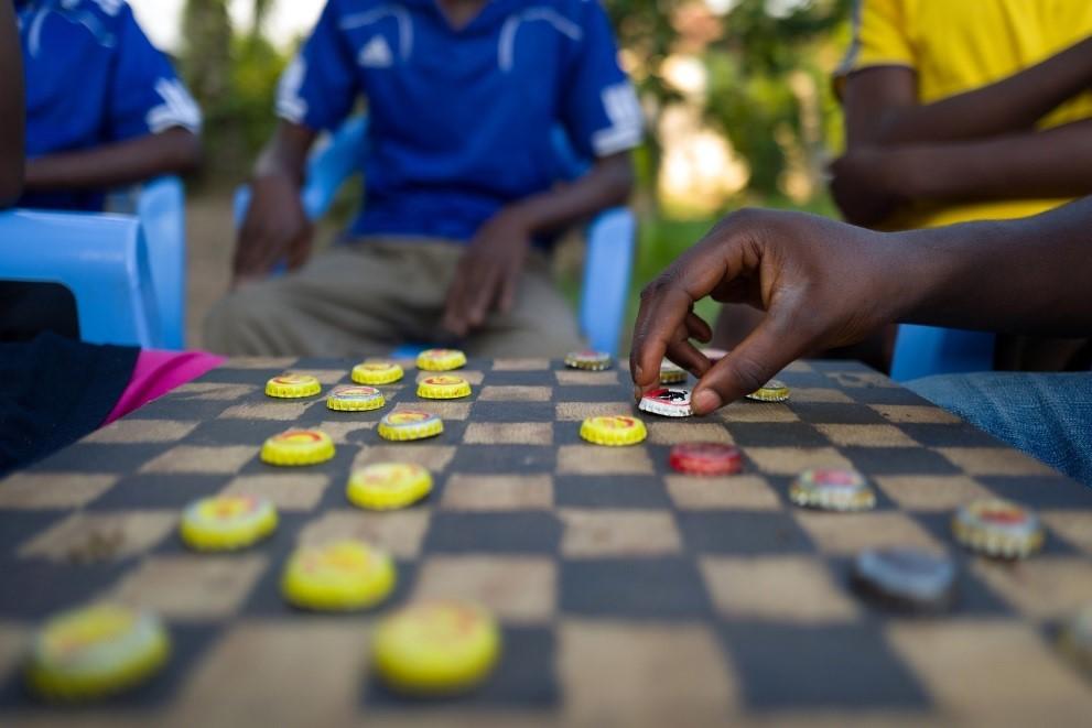 children play a game of checkers