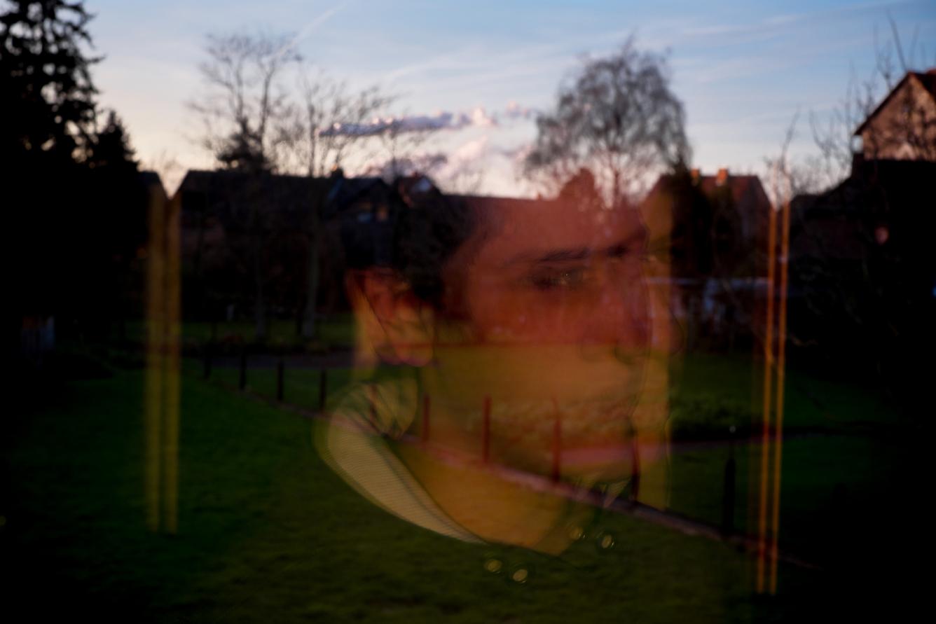 Ahmed, 15 ans, dans le reflet d’une vitre sur le trajet du retour chez lui