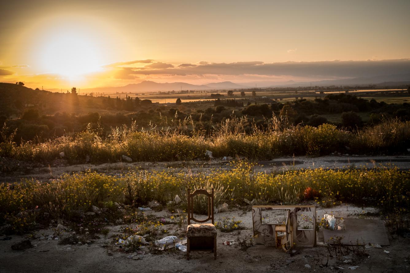 a chair sits on a section of a road in sicily