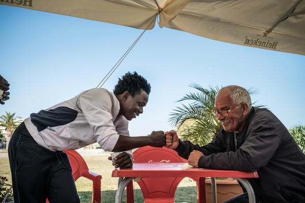 Mohammed fist bumps with a local resident