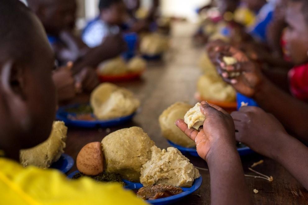 children share a meal at a child-friendly space