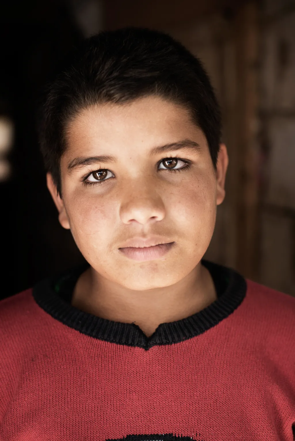 Syrian refugee Ali, 13, who attends school, stands for a photograph.