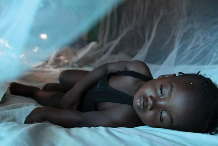 Child under mosquito net