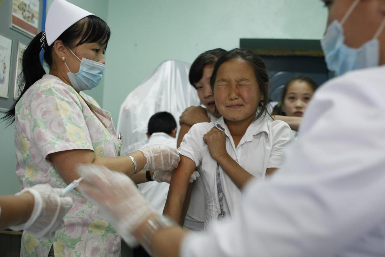 A girl winces while a health worker vaccinates her against measles and rubella at a school in Ulaanbaatar.