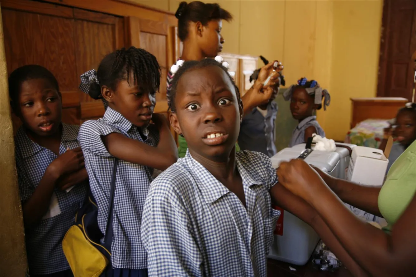 A schoolgirl is immunized in Port-au-Prince, Haiti during a nationwide vaccination campaign.
