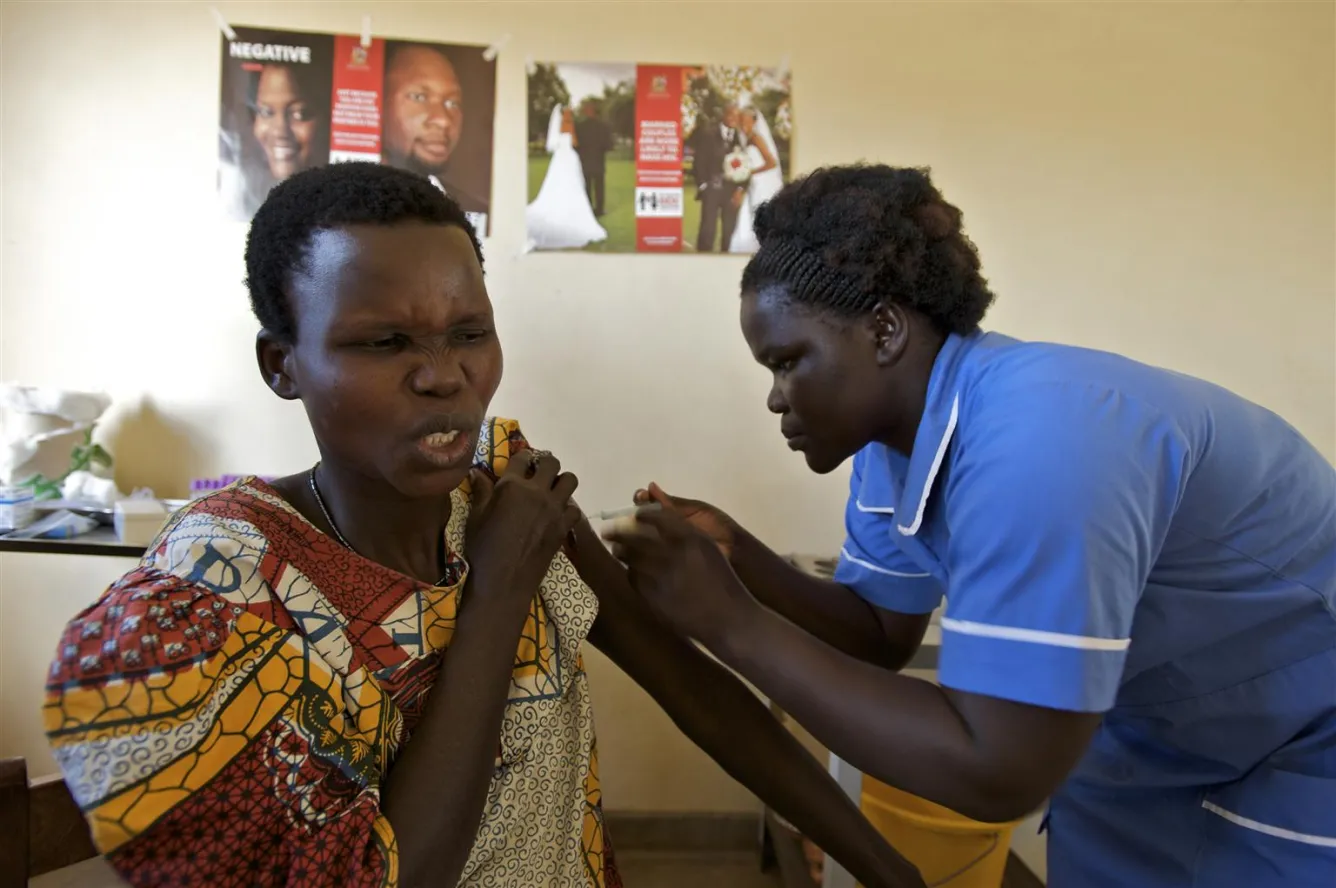 At a maternal and child health unit in Pazongo, a woman winces as she receives a tetanus vaccine.
