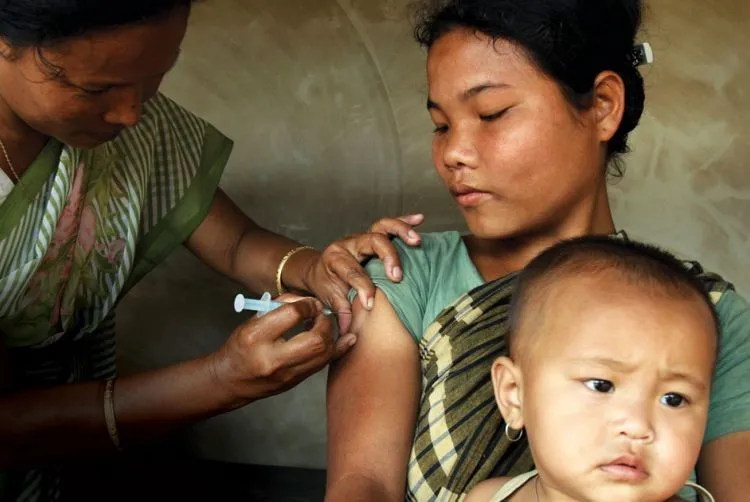 A woman receives a vaccine from a local nurse.