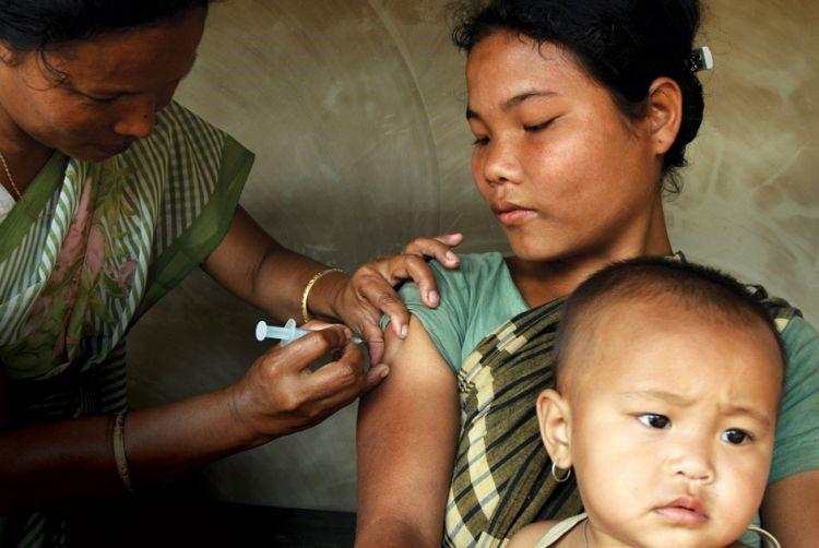 A woman receives a vaccine from a local nurse.