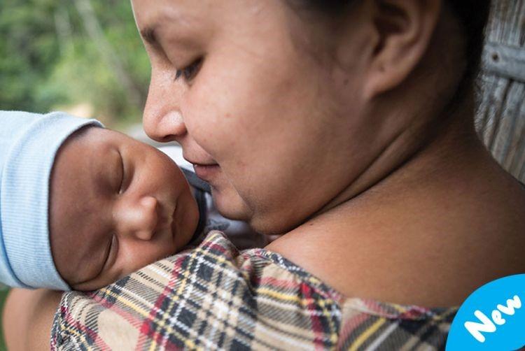 A mother holds her newborn baby.